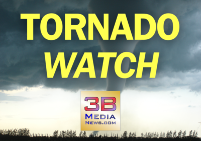 Graphic showing a dark stormy sky with a visible tornado touching down in the distance. Bold yellow text over the image reads "TORNADO WATCH." At the bottom center is the 3B Media News logo.