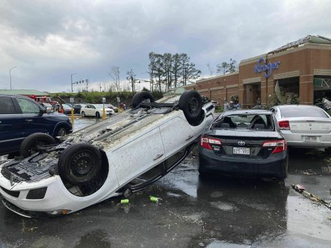 A car is upturned in a Kroger parking lot after severe storm swept through Little Rock, Ark., Friday, March 31, 2023. (AP Photo/Andrew DeMillo)